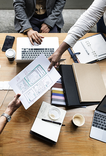 Overhead shot of businesspeople collaborating a meeting table.